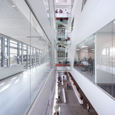 Multi-storey lightwell with bridging study pods. Extensive glazing and multi-storey voids allow circulation through the building to be animated by views to different levels, and, wherever possible, into teaching spaces. Photo by Andrew Latreille.