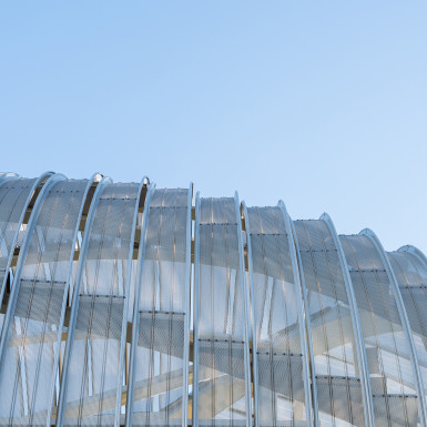 Detail view of the perforated metal scrim. Inspired by the perpetual dynamism of highway traffic and railway lines, the bridge’s streamlined curvilinear metal enclosure was digitally modelled and refined in 3D to capture the sense and vision of speed through surface modelling. Photo by Michael Muraz.