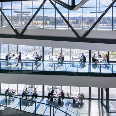 View from of the forum / quad facing the Otonabee River. Generous glazing along the south façade allows for ample low-angle winter light to reach deep into the student centre. Photo by Andrew Latreille.