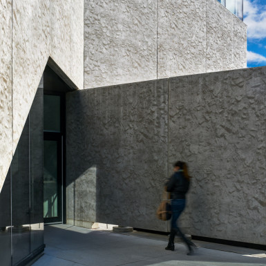 The precast concrete ‘ribbon’ is folded and sculpted to articulate building entrances. Photo by Andrew Latreille.