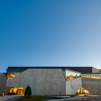 Overall dusk view of precast concrete wrapping the east face of the building. Photo by Andrew Latreille.